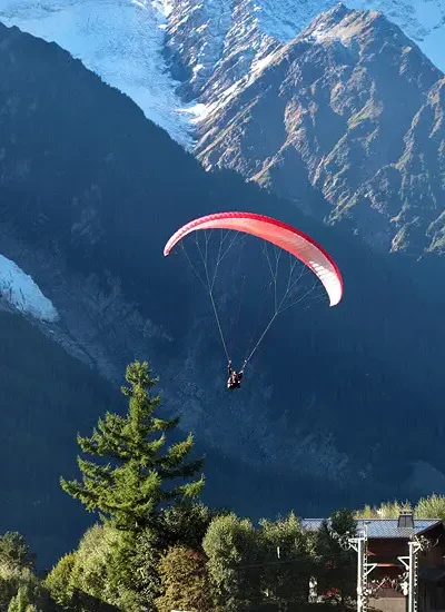 Traveler enjoying breathtaking mountain views surrounded by alpine landscapes and hiking trails.