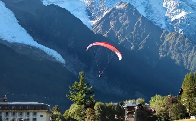 Traveler enjoying breathtaking mountain views surrounded by alpine landscapes and hiking trails.